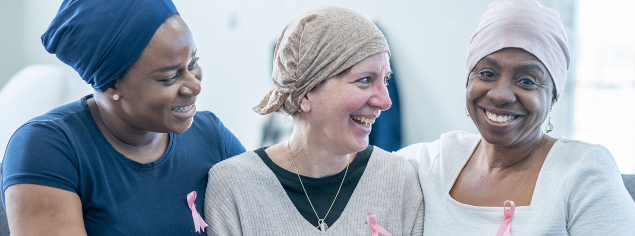 survivorship-three-women-smiling-sitting-together-oc